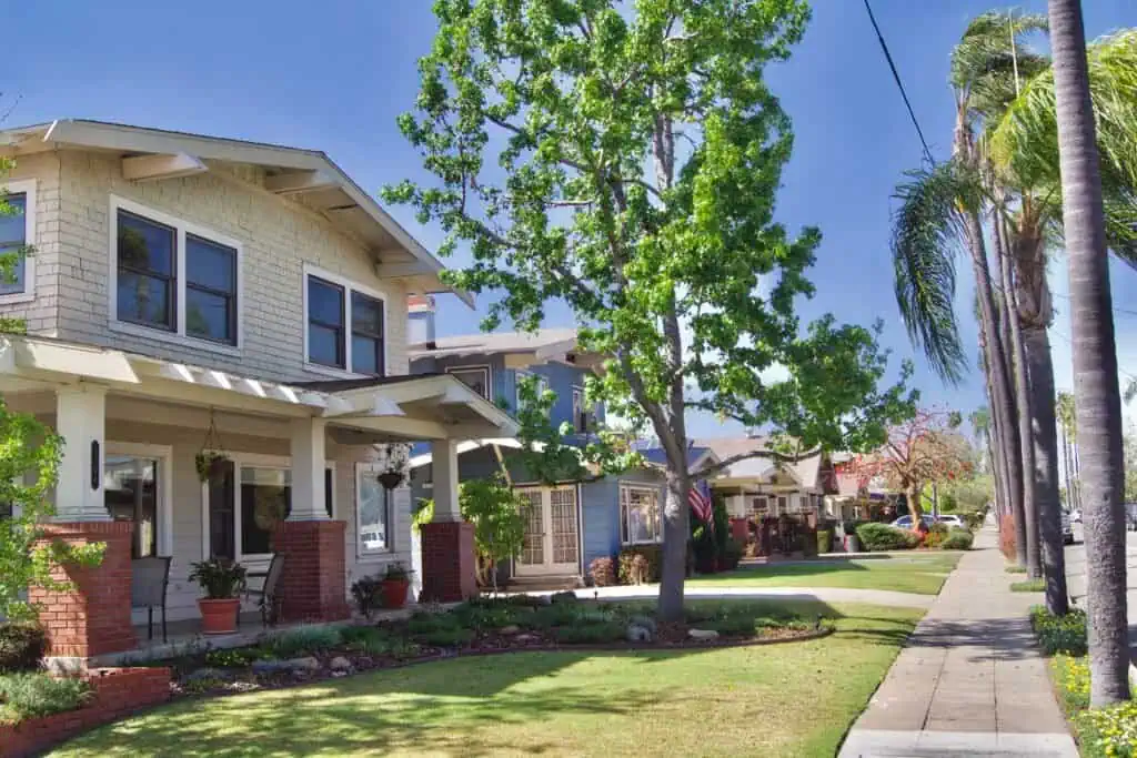 Beautiful residential front yard with lush green lawn and mature trees.